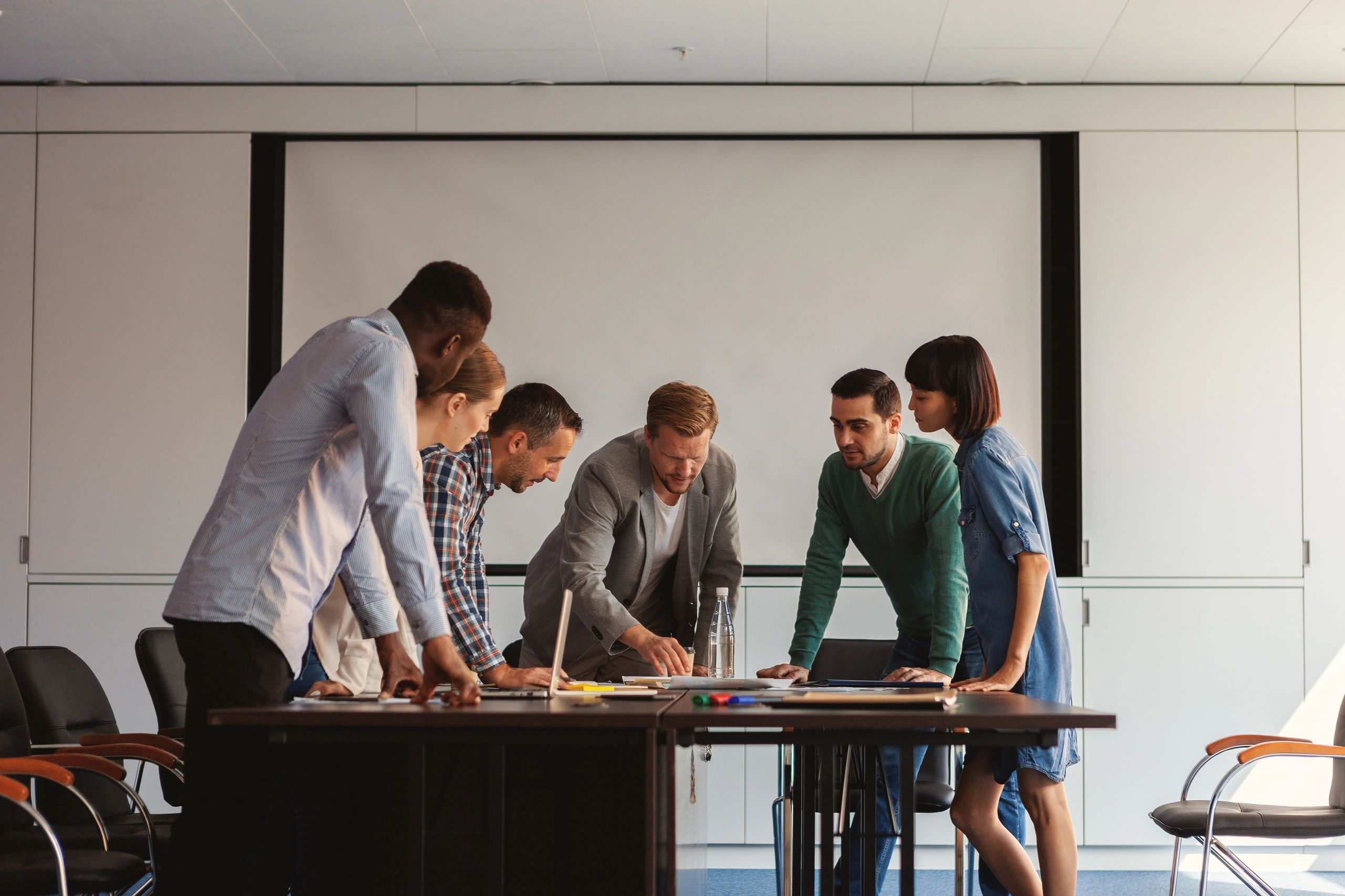 Diverse team collaborating around a table on business strategy
